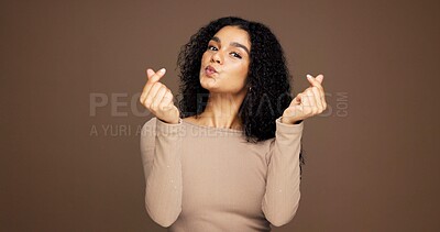 Buy stock photo Finger heart, kiss and portrait of woman in studio for support, kindness and thank you. Gratitude, pouting and emoji sign with person on brown background space for love gesture and care symbol