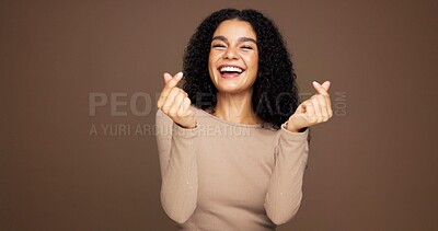 Buy stock photo Finger heart, smile and portrait of woman in studio for support, kindness and thank you. Gratitude, happiness and emoji sign with person on brown background space for love gesture and care symbol