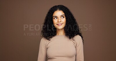 Buy stock photo Thinking, smile and woman with hair care in studio with ideas for natural, beauty or cosmetics. Happy, choice and female person with decision for healthy curly hairstyle for glow by brown background.