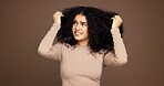 Mistake, hair and woman in studio with frizz problem, dry texture and split ends on brown background. Hairdresser, salon and person with worry for haircare treatment, curly routine and grooming