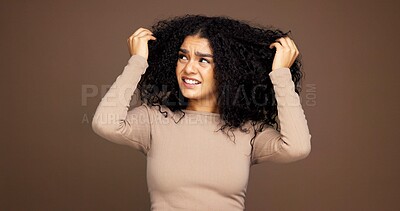 Buy stock photo Mistake, hair and woman in studio with frizz problem, dry texture and split ends on brown background. Hairdresser, salon and person with worry for haircare treatment, curly routine and grooming