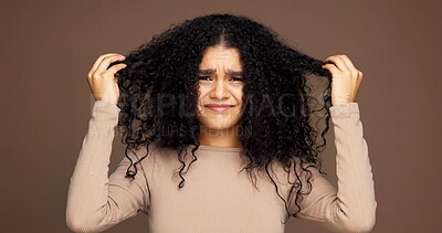 Buy stock photo Portrait, hair and woman in studio with damage, frizz problem and dry texture on brown background. Hairdresser, salon and person with for haircare treatment, curly routine and grooming for health