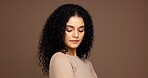 Studio, hair care and woman with natural beauty, growth and volume on brown background. Curly hairstyle, serious and female model with cosmetics for hairdresser or salon treatment with mockup space