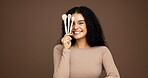 Portrait, woman and brushes for makeup in studio background, beauty makeover and glamour. Happy, female person and cosmetic tools for transformation shine, foundation application and aesthetics glow