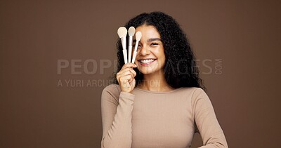 Buy stock photo Portrait, woman and brushes for makeup in studio background, beauty makeover and glamour. Happy, female person and cosmetic tools for transformation shine, foundation application and aesthetics glow