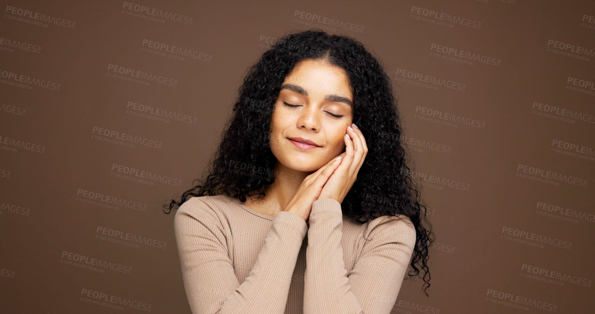 Buy stock photo Skincare, hands and face of woman in studio with satisfaction, cosmetics and facial care. Mockup space, salon aesthetic and person with natural beauty, wellness and healthy skin on brown background