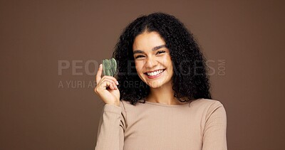 Buy stock photo Gua sha, skincare and portrait of woman in studio for facial care, detox and lymphatic drainage. Dermatology, spa and person with jade tools for anti aging, massage or smooth skin on brown background