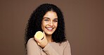 Portrait, woman and lemon for beauty in studio for vitamin c, brighten skin and natural detox. Female person, citrus and fruit for organic benefits, skincare and exfoliate results on brown background