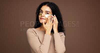 Buy stock photo Portrait, woman and eye patches for skincare, detox and hydration on brown studio background. Face, cosmetics and model with gel mask for beauty, dermatology or facial application with mockup space