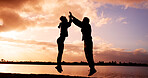 Silhouette, couple and jump with high five at river for winning, success or achievement together. Excited, man and woman in sunset with touch for teamwork, accomplishment or fitness goals at lake