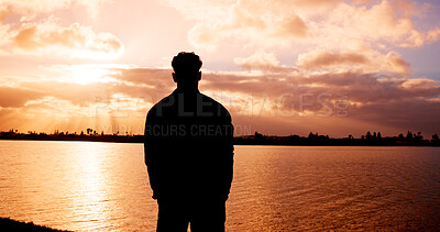 Buy stock photo Silhouette, man and back view with sunset at river for scenary, fresh air or outdoor journey. Male person, nature and water with sunlight reflection for evening activity, holiday or weekend at lake