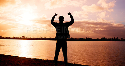 Buy stock photo Silhouette, man or back view with fist pump at river for winning, achievement or conquer in sunset. Active, male person or celebration with success for accomplishment, done or freedom at pond or lake