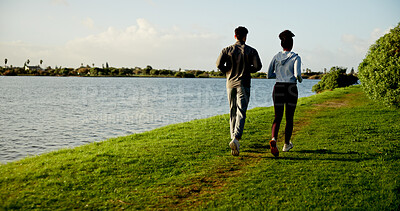Buy stock photo Exercise, running and sky with couple outdoor at lake in nature for cardio training from back. Environment, field and fitness with people on space in park together for health, wellness or workout