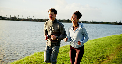 Buy stock photo Happy couple, fitness and running on grass field by lake for workout, exercise or training together. Active, man and woman with smile or race for cardio, physical activity or marathon by riverside