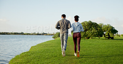 Buy stock photo Fitness, running and sky with couple outdoor at lake in nature for cardio training from back. Environment, exercise and field with people on space in park together for health, wellness or workout