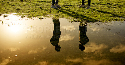 Buy stock photo People, fitness or reflection with puddle for workout discussion, routine or sunset exercise. Silhouette, man and woman talking on grass field at lake or pond for physical activity together in nature