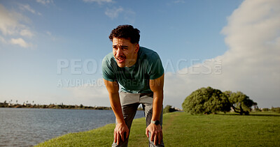 Buy stock photo Tired, active and man for fitness outdoor from running, sports exercise and workout break. Thinking, male person and rest with breathing recovery, cardio training and marathon practice at park lake