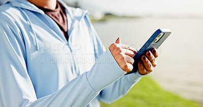 Buy stock photo Woman, hands and fitness with phone at lake for social media, workout routine or tracking app. Closeup, female person or browsing with mobile smartphone for physical activity or health tips at river