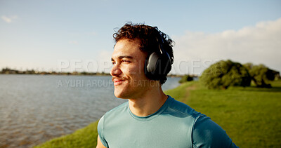 Buy stock photo Headphones, happy man or athlete thinking in lake for outdoor training, workout or exercise. Smile, inspiration or sports runner on break for streaming radio, music audio or fitness podcast to relax