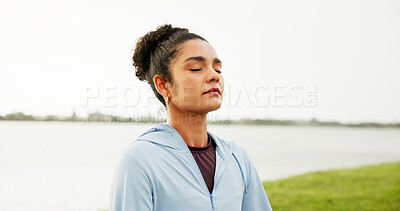 Buy stock photo Calm, woman and yoga with grass field for meditation, zen or spiritual healing by lake or river. Female person, yogi or wellness with inner peace for tranquility, chakra or mudra on lawn in nature
