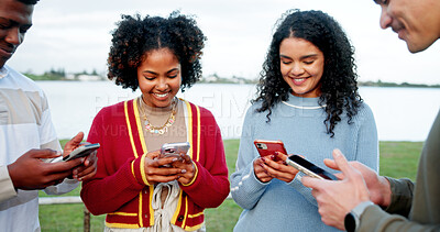 Buy stock photo Phone, smile and social media with friends outdoor in circle for connection, networking or sharing. App, text message and typing with happy student people at lake in nature for mobile communication