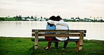 Back view, lake and couple on park bench on vacation, holiday and hug for bonding. Embrace, man and woman sightseeing by water together for love, support or connection for relax with space for travel