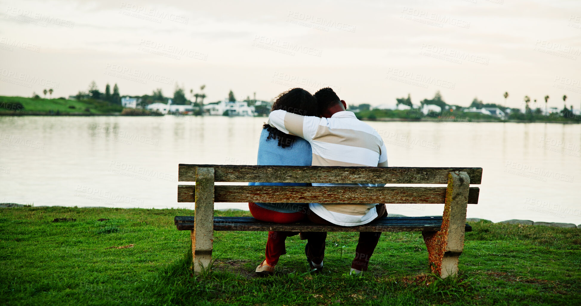 Buy stock photo Back view, lake and couple on park bench on vacation, holiday and hug for bonding. Embrace, man and woman sightseeing by water together for love, support or connection for relax with space for travel