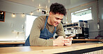 Food truck, happy and man with phone at counter for social media, internet and online on break. Mobile cafe, restaurant vendor and person on smartphone for typing message, chatting and connection