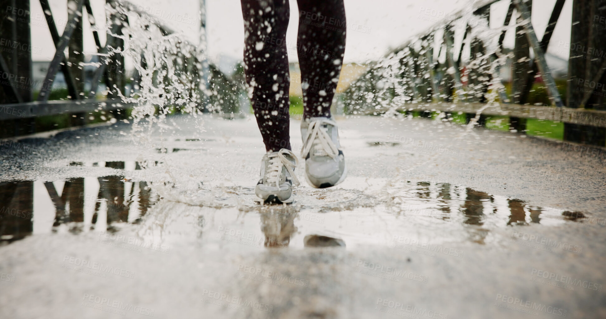 Buy stock photo Exercise, puddle and shoes running with splash on bridge for endurance, winter workout or sports. Fitness, legs and person with cardio outdoor for race performance, marathon competition and challenge