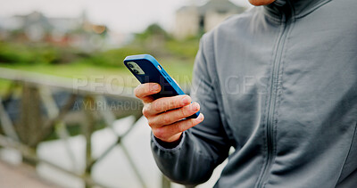 Buy stock photo Exercise, break and hands with phone on bridge for fitness app, check stats or workout performance. Runner, person and smartphone in nature for cardio progress, track running speed and training timer