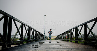 Buy stock photo Running, bridge and man in city for exercise, marathon training and workout for challenge. Sports, runner and person for wellness, performance and health in winter for endurance, cardio and fitness