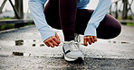 Hands, fitness and woman tying laces outdoor for running, race or marathon training with sneakers. Sports, shoes and female athlete preparing for cardio, workout or exercise in nature for wellness.