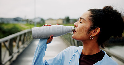 Buy stock photo Drinking water, runner and health with woman in city for fitness, hydration and workout break. Wellness, sports electrolytes and exercise with person and bottle outdoor for marathon and recovery