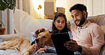 Dog, relax and tablet with couple in new home for moving house, property investment or relocation. App, boxes and real estate with happy people in living room of apartment for break together