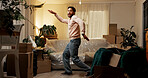 Moving, dancing and man in new home with boxes with fun for property investment with music. Happy, goofy and male person listening to playlist, song or radio with groove in living room at house.
