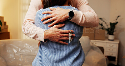 Buy stock photo Love, couple and key for new house, moving and achievement for newlyweds in living room or mortgage. Property investment, people and embrace in home, bonding and boxes for relocation and milestone