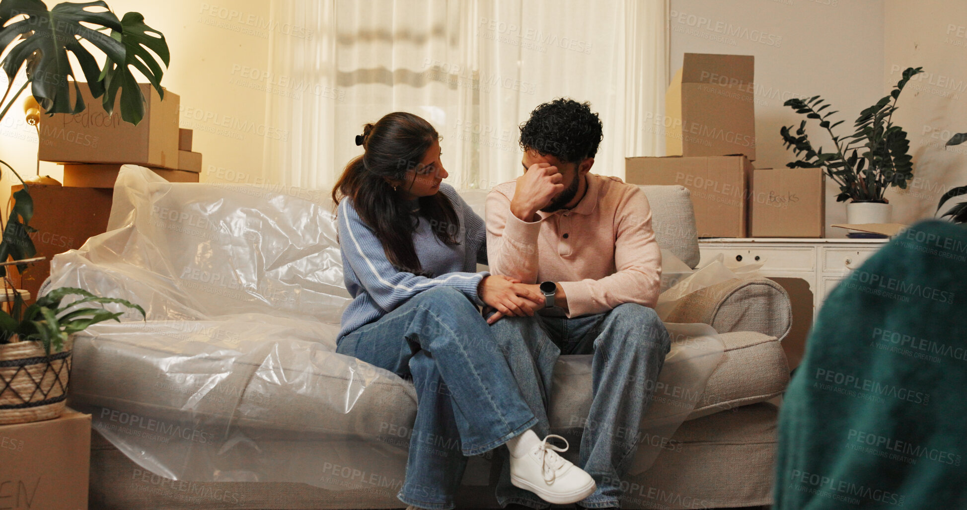 Buy stock photo Sad, eviction and couple with boxes in home for foreclosure notice, moving out and lease violation. Night, stress and people with support on sofa for mortgage crisis, financial issue and repossession