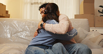 Buy stock photo Bonding, couple and hug in new house, love and achievement for newlyweds in living room or mortgage. Investment, home and embrace for milestone, relocation and people in lounge with boxes and moving