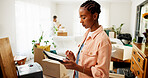 Tablet, moving and black woman in new house for research on renovations, interior design or online shopping. Digital technology, cardboard boxes and female person on app for ecommerce purchase.