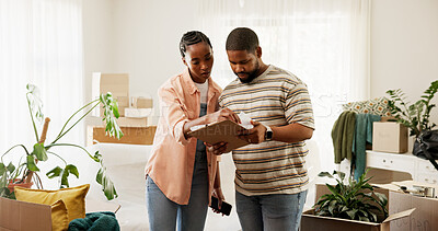 Buy stock photo Boxes, clipboard and moving house with black couple in living room for planning or relocation. Checklist, conversation and real estate with people in home for discussion, packing or property task