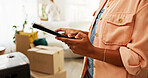 Tablet, moving and hands of woman in new house for research on renovations, interior design or online shopping. Digital technology, cardboard boxes and female person on app for ecommerce purchase.