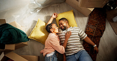 Buy stock photo Above, black couple and relax on floor of new home, happy and love with real estate dream. Man, woman and smile in living room with rest, investment opportunity and tired from moving in with comfort