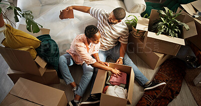 Buy stock photo Unpacking, couple and people with boxes, moving in and bonding in new house, mortgage or investment. Relocation, black man and woman with cardboard in living room, real estate and unboxing in home