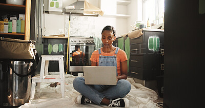Buy stock photo Painting, laptop and woman in home for renovation, interior design or online shopping for supplies. Computer, remodeling kitchen and African person on floor for house improvement with creative ideas