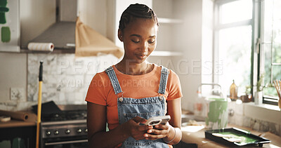 Buy stock photo Painting, phone and woman in home for renovation, interior design or chat for diy upgrade. Mobile, remodeling kitchen and happy African person research for house improvement with creative inspiration