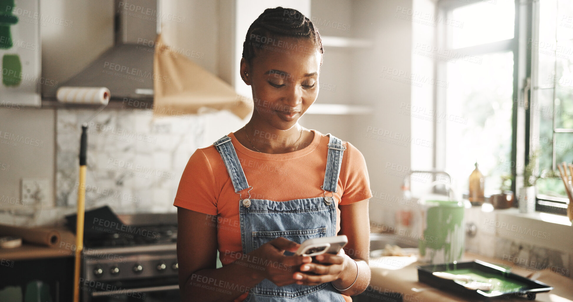 Buy stock photo Painting, phone and woman in home for renovation, interior design or chat for diy upgrade. Mobile, remodeling kitchen and happy African person research for house improvement with creative inspiration