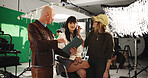 Woman, actress and director with clipboard in studio for scene notes, feedback and filming advice. People, makeup artist and backstage prep for movie production, performance guide and explain script
