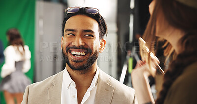 Buy stock photo Actor, man and makeup artist in production studio to prepare for movie on set. Brush, happy celebrity and stylist behind the scenes for beauty, cosmetic touch up and laughing with funny joke for film