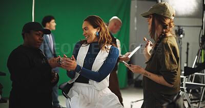 Coffee, happy and woman model with makeup artist on set for behind the scenes preparation. Assistant, cappuccino and female person with cosmetology team for magazine photoshoot in creative studio.