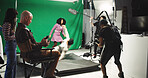 People, acting and filming with stabilize in studio for commercial, production process and record. Crew, actor and actress with cameraman on set for shooting scene, action movie and rehearsal footage